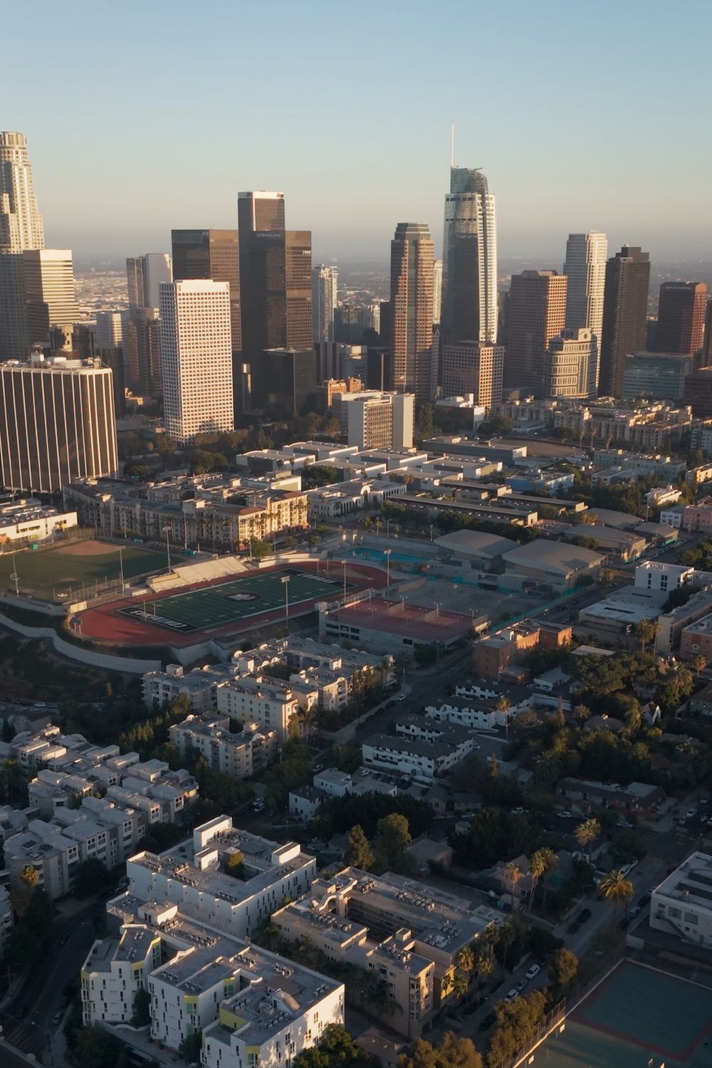 Aerial view of the downtown Los Angeles skyline above a grid of low-rise streets